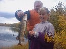 Ken: 'Here, hold your fish up for the camera.' Tara: 'Eeeeewwww! Touch it?'